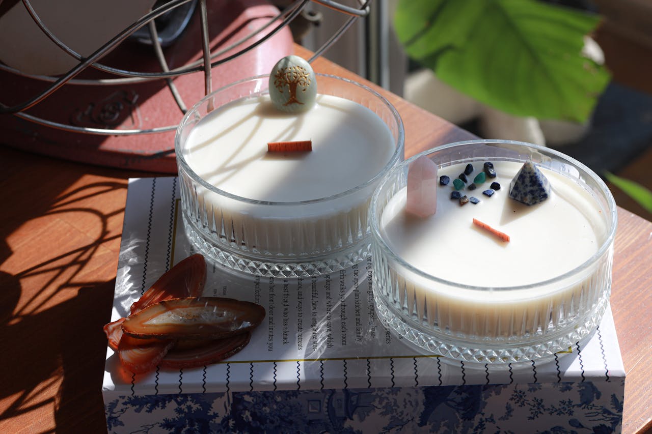 Two exquisite homemade candles decorated with artistic elements, perfect for home decor inspiration.